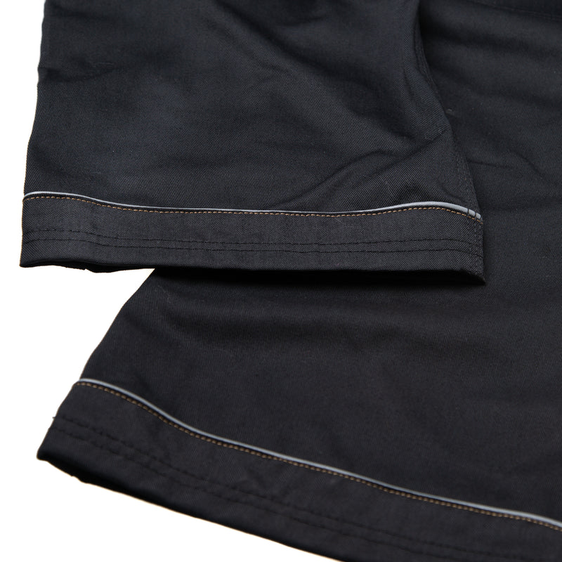 Close-up of the durable fabric and triple stitching on the black holster trousers.