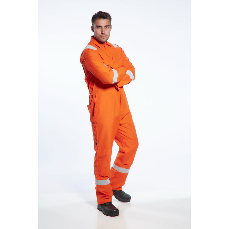 Worker in an industrial setting wearing the Araflame Gold Coverall AF53.