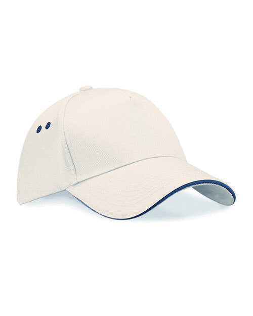 Flat lay of a putty and French navy Beechfield B15C snapback trucker cap.