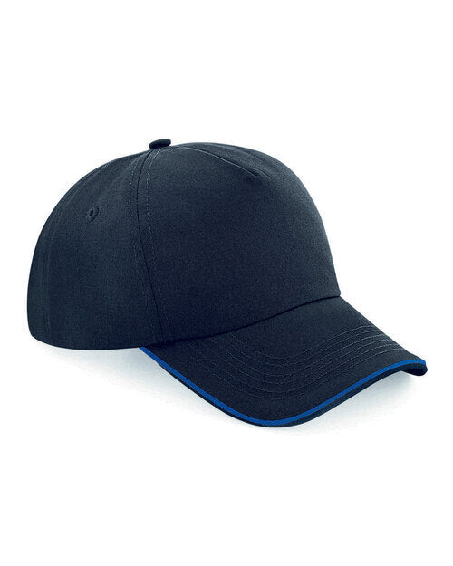 Flat lay of a Beechfield B25C youth trucker cap in black and brown.
