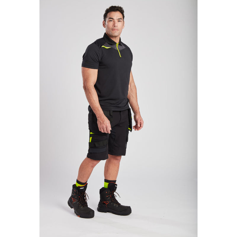 Side view of a man wearing the slim-fit black Portwest DX4 Polo Shirt.