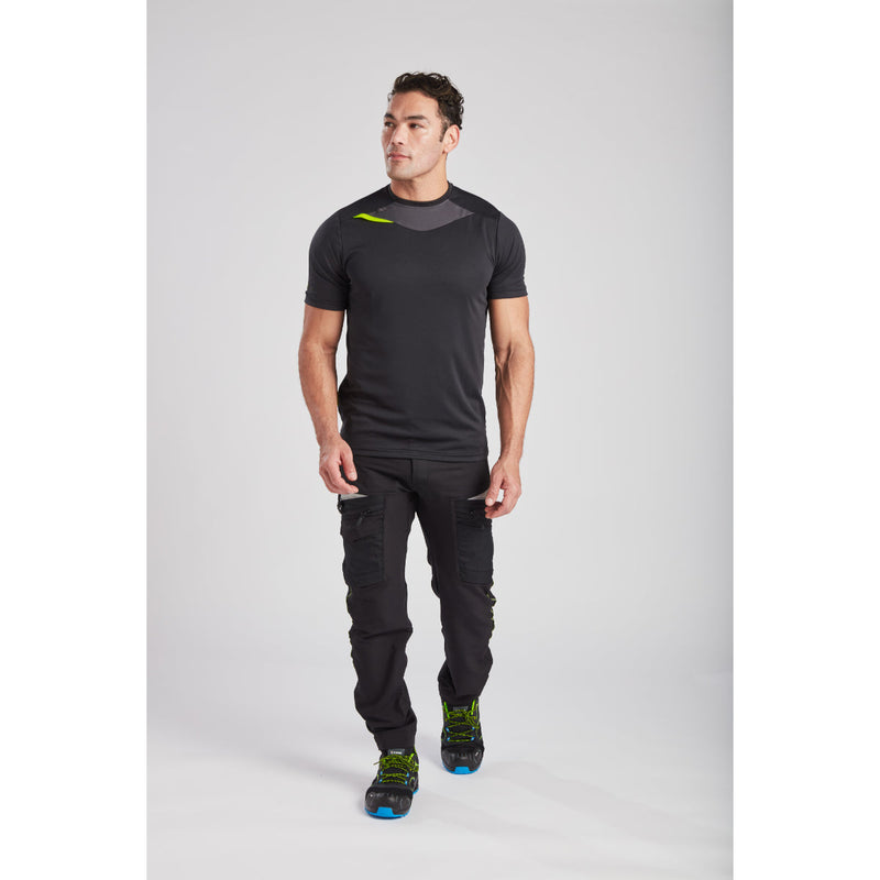 Man wearing the metro blue Portwest DX4 T-Shirt with grey work trousers.