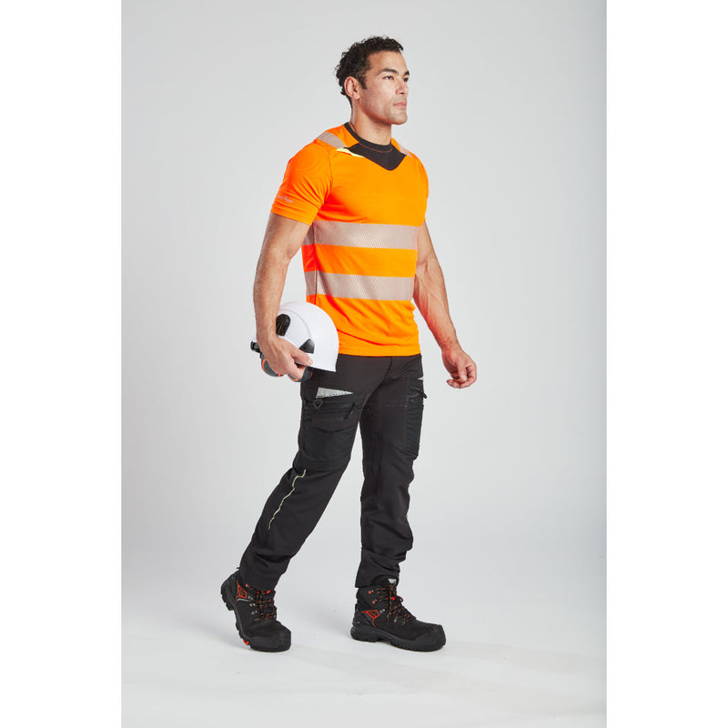 Rear view of a worker in the yellow Portwest DX4 t-shirt and matching work trousers.