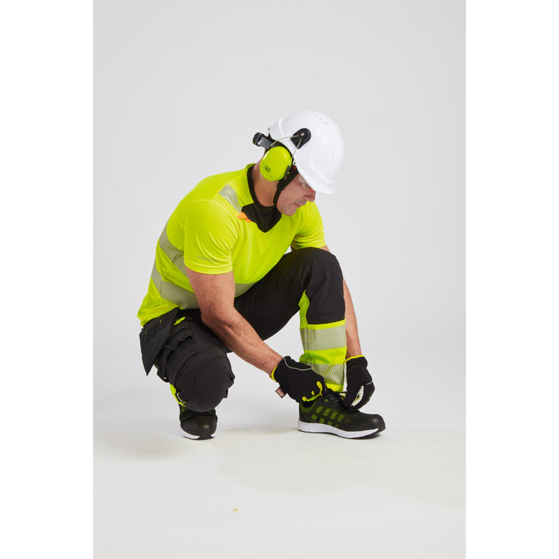 Back perspective of a worker leaning forward in the yellow Portwest DX4 hi-vis t-shirt.
