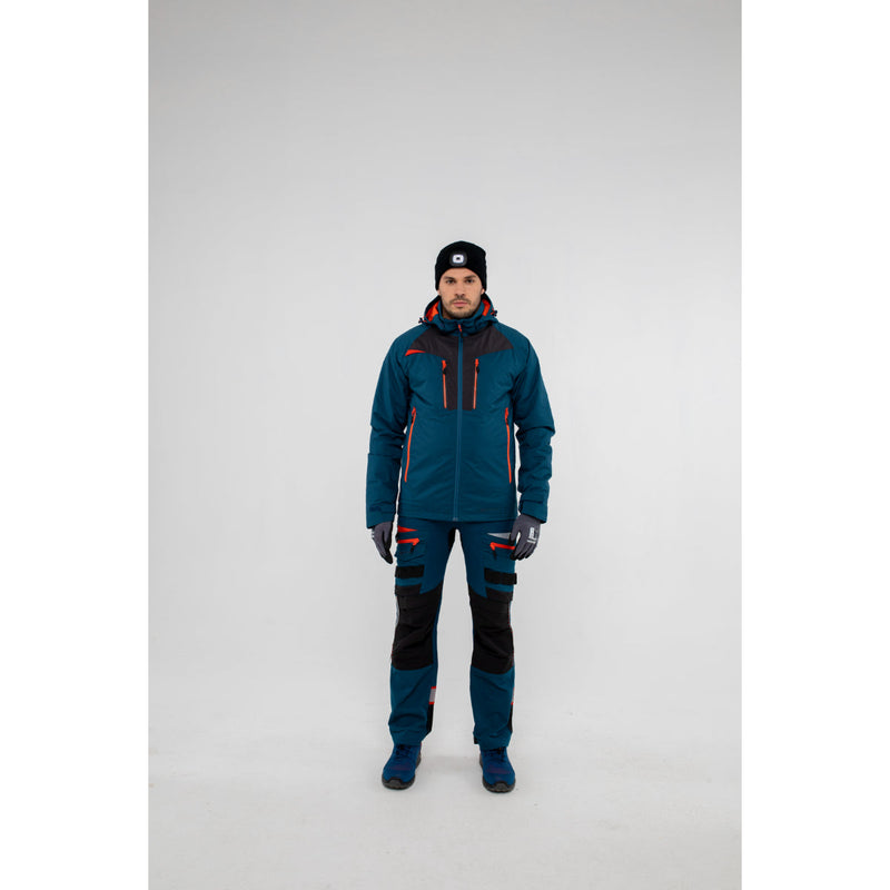 Side profile of a model wearing the blue Portwest hooded winter jacket.