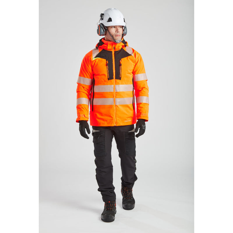 A model in Portwest winter workwear with a helmet and attached PW62 ear muffs.