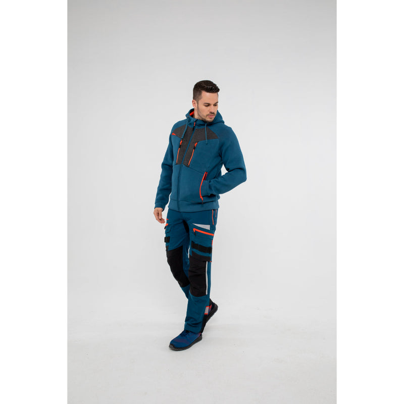 Man in Portwest DX4 Zipped Hoodie long-sleeve top and work trousers in an industrial setting.