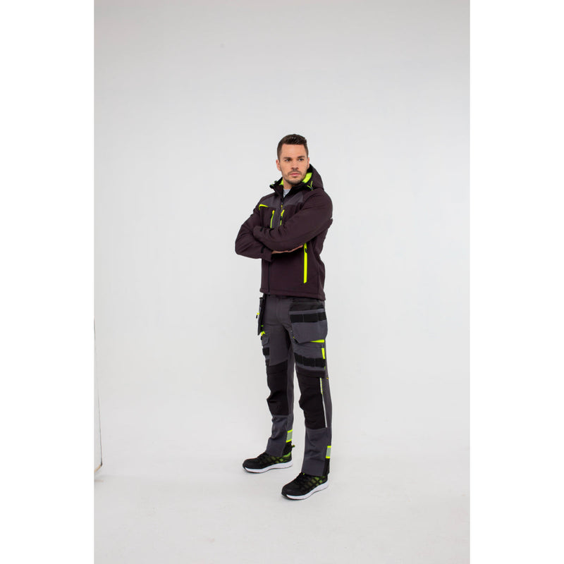 Back view of a man in Portwest DX4 Softshell 3L jacket showing hood details.