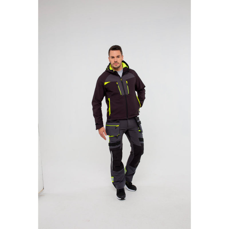 Man in Portwest DX4 Softshell 3L jacket demonstrating bending at the waist.