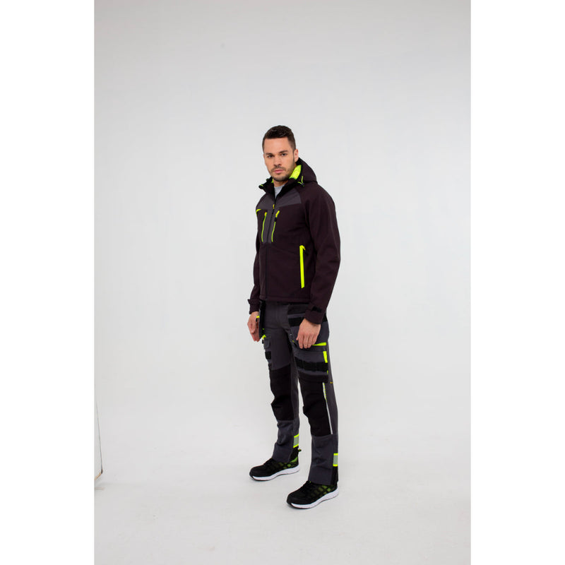 Man in Portwest DX4 Softshell 3L jacket with hands in pockets casual pose.