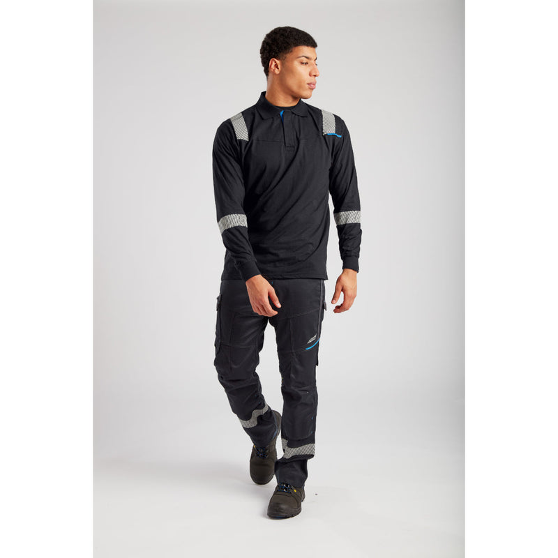 Worker wearing Portwest FR workwear in an industrial setting.