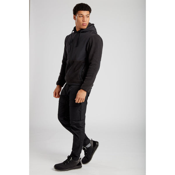 Model wearing Portwest KX3 Drawstring Combat Trousers with a matching KX3 softshell jacket.