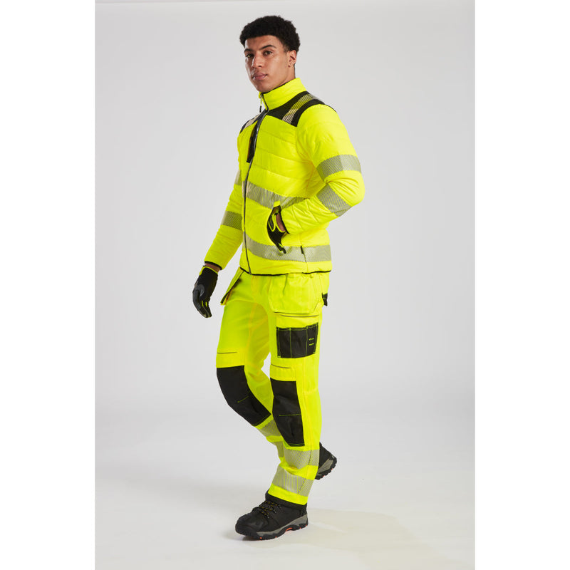 Lifestyle shot of a worker wearing T501 Yellow/navy trousers.