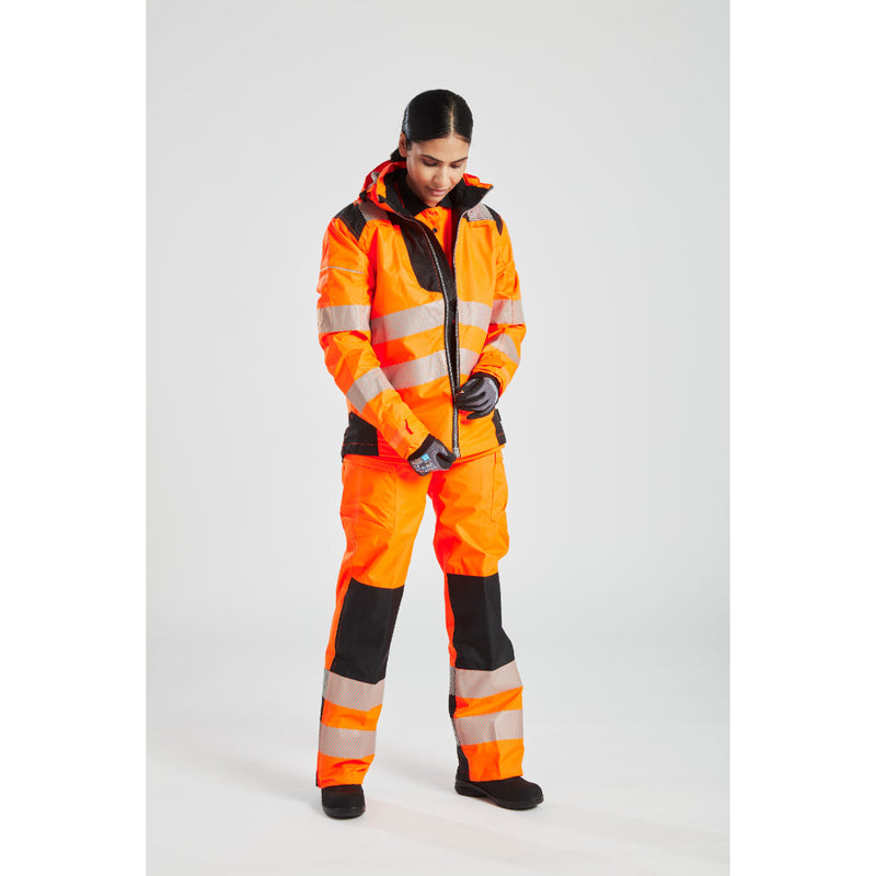 A woman wearing the orange Portwest PW3 Hi-Vis Winter Jacket, showing the front design.