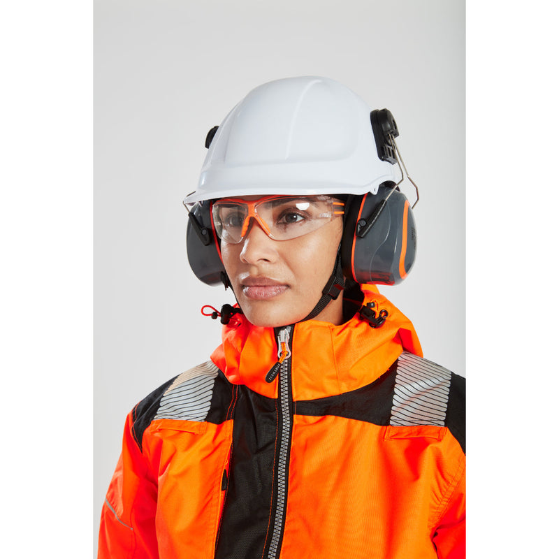 A woman wearing the orange Portwest PW3 Winter Jacket with a hard hat and safety glasses.