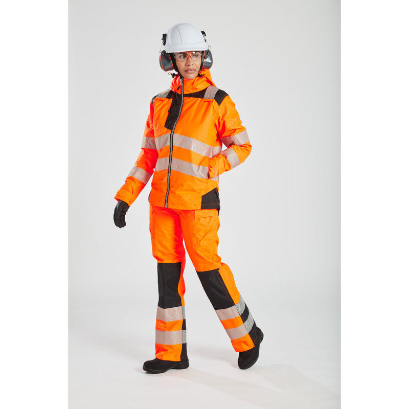 A woman in a Portwest PW3 jacket discussing plans with a coworker on a construction site.