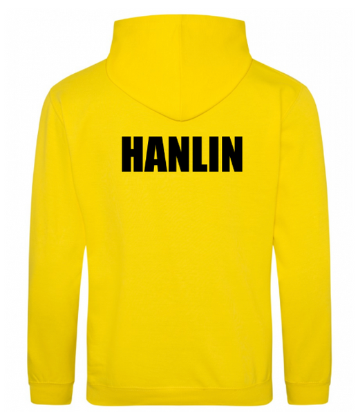 A focused composition on the embroidered Armadale PS crest on a yellow kids' hoodie.