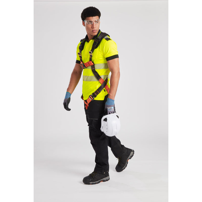Worker fastening safety lanyard to anchor point while wearing full protective gear