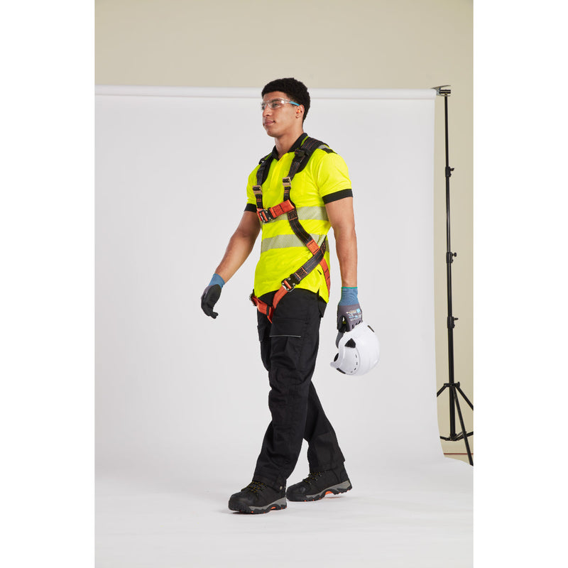 Safety professional checking harness fit and lanyard attachment on rooftop worksite