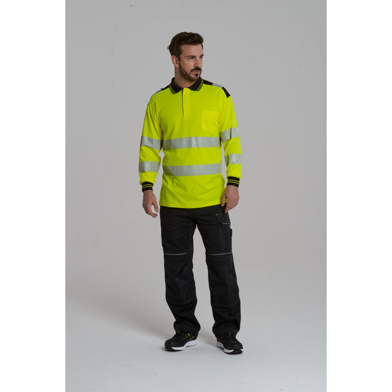 A man wearing Portwest Ttrousers and a softshell jacket.