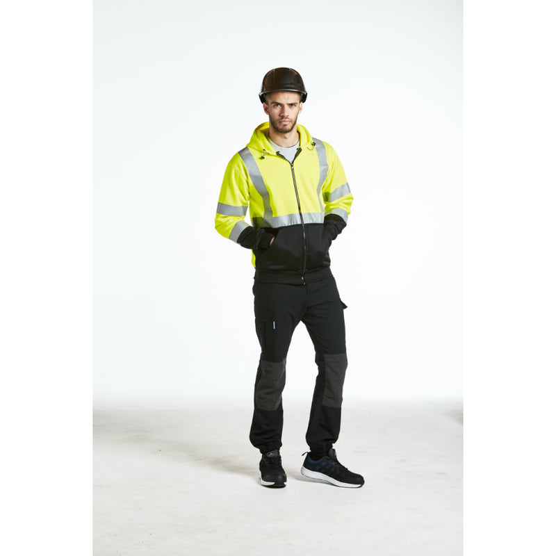 Worker looking at plans while wearing the comfortable Portwest PC55 helmet.