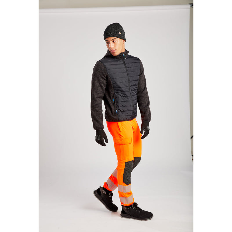 Side view of a model in the full Portwest KX3 Hi-Vis workwear set.