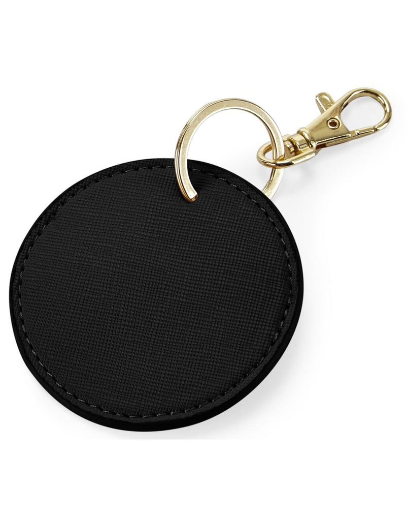 The Bagbase Boutique Circular Key Clip in black Saffiano faux leather with gold hardware.