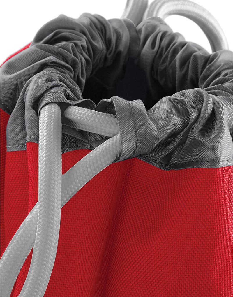 A person wearing the black Bagbase Athleisure Gymsac, demonstrating its practical size and stylish fit.