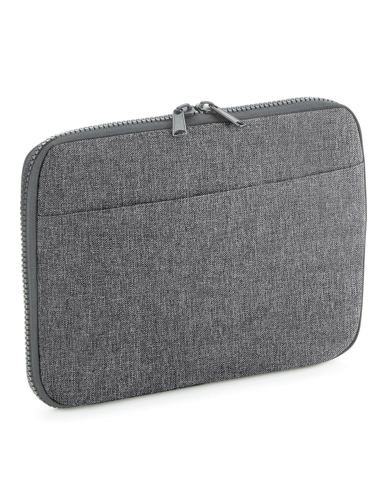 The black Bagbase Essential Tech Organiser filled with tech accessories to demonstrate its capacity.