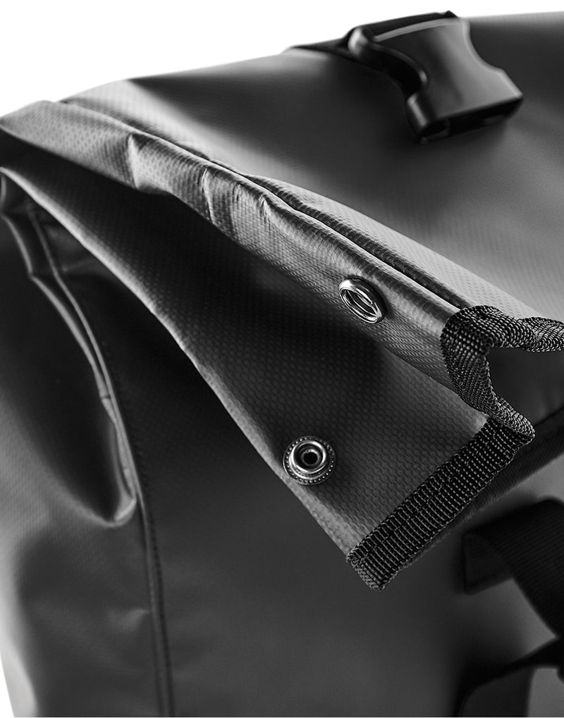 Black waterproof tarpaulin roll-top backpack.