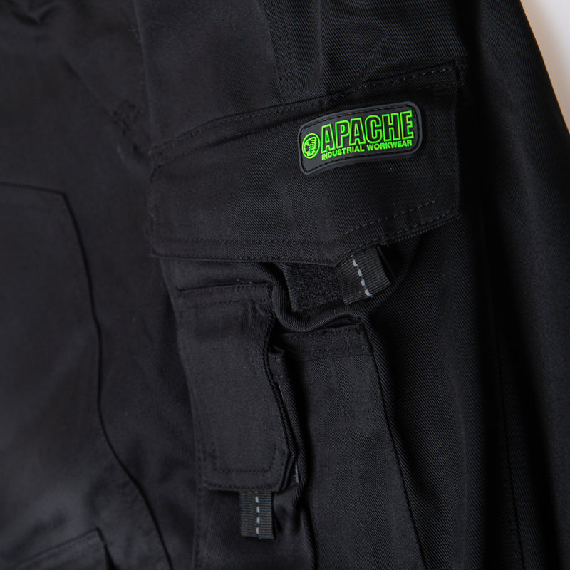 Detail shot of the reinforced knee pad pocket on the black APKHT trousers.