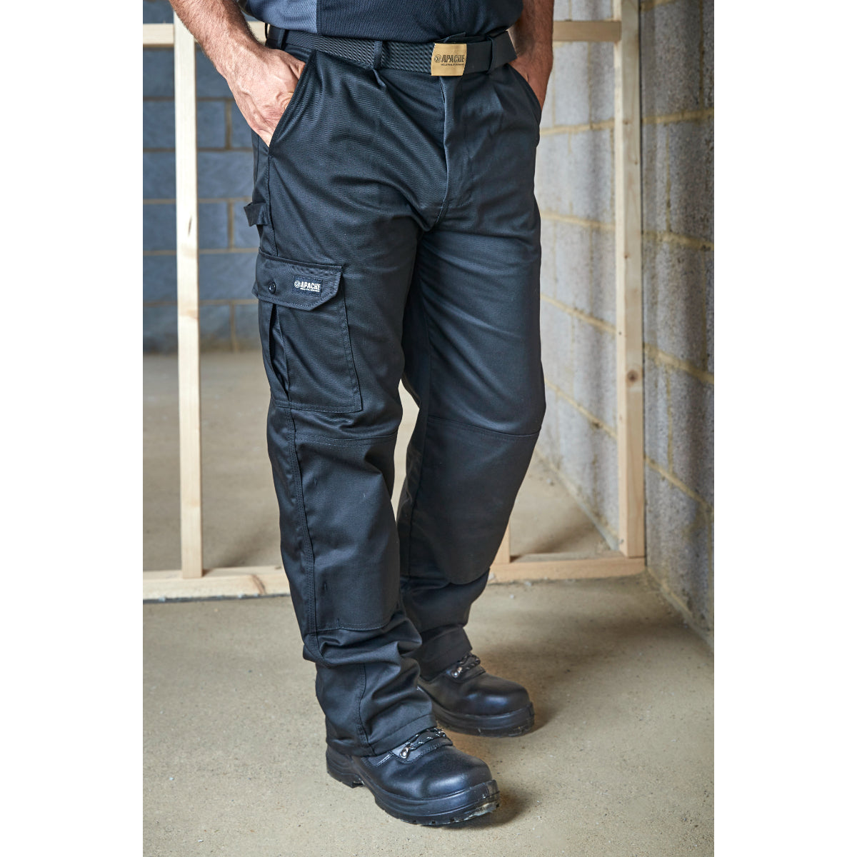 Close-up of the button and belt loop detail on the APINDBLACK trousers.