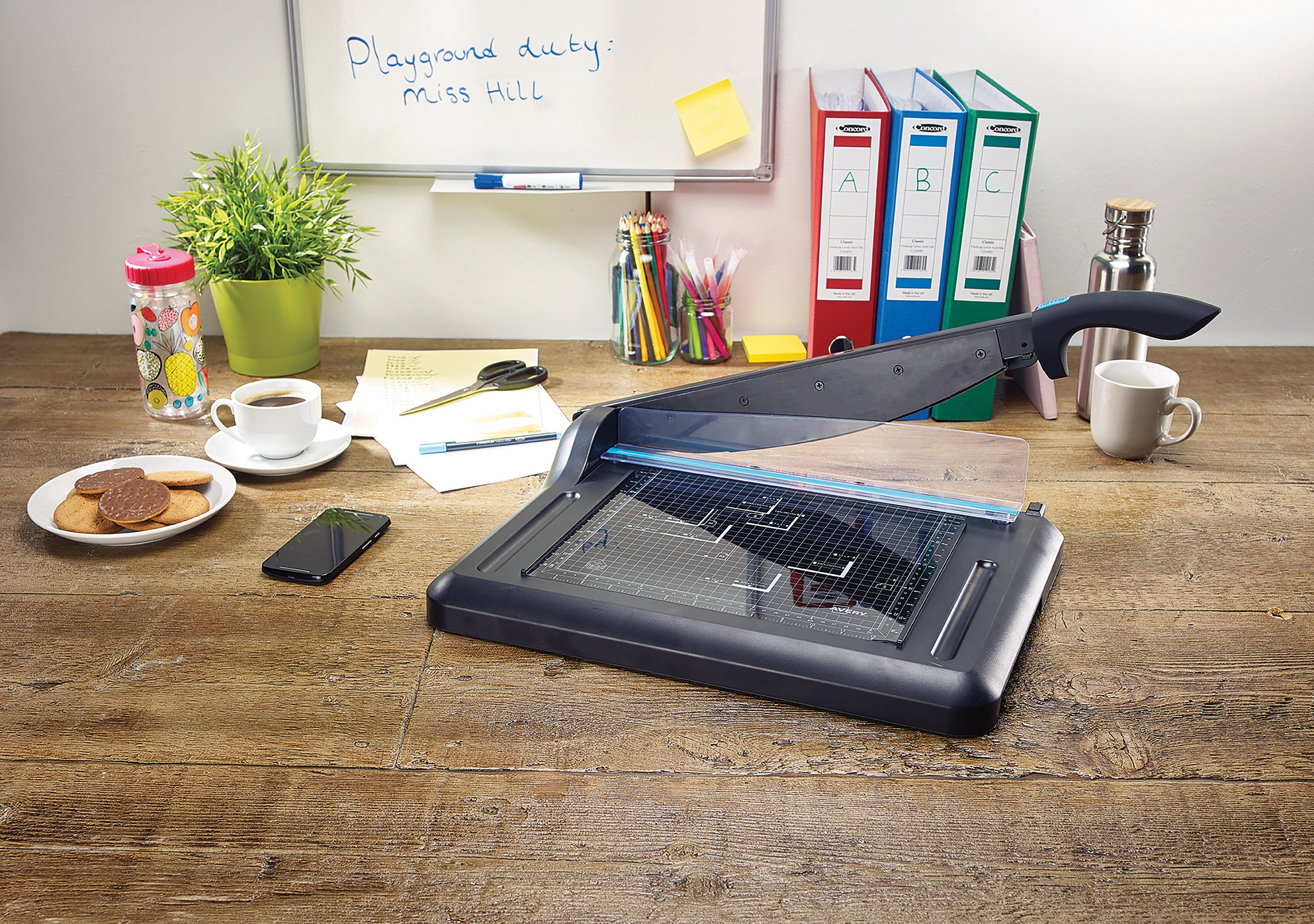 A person using the Avery A4 guillotine for a clean, straight cut.