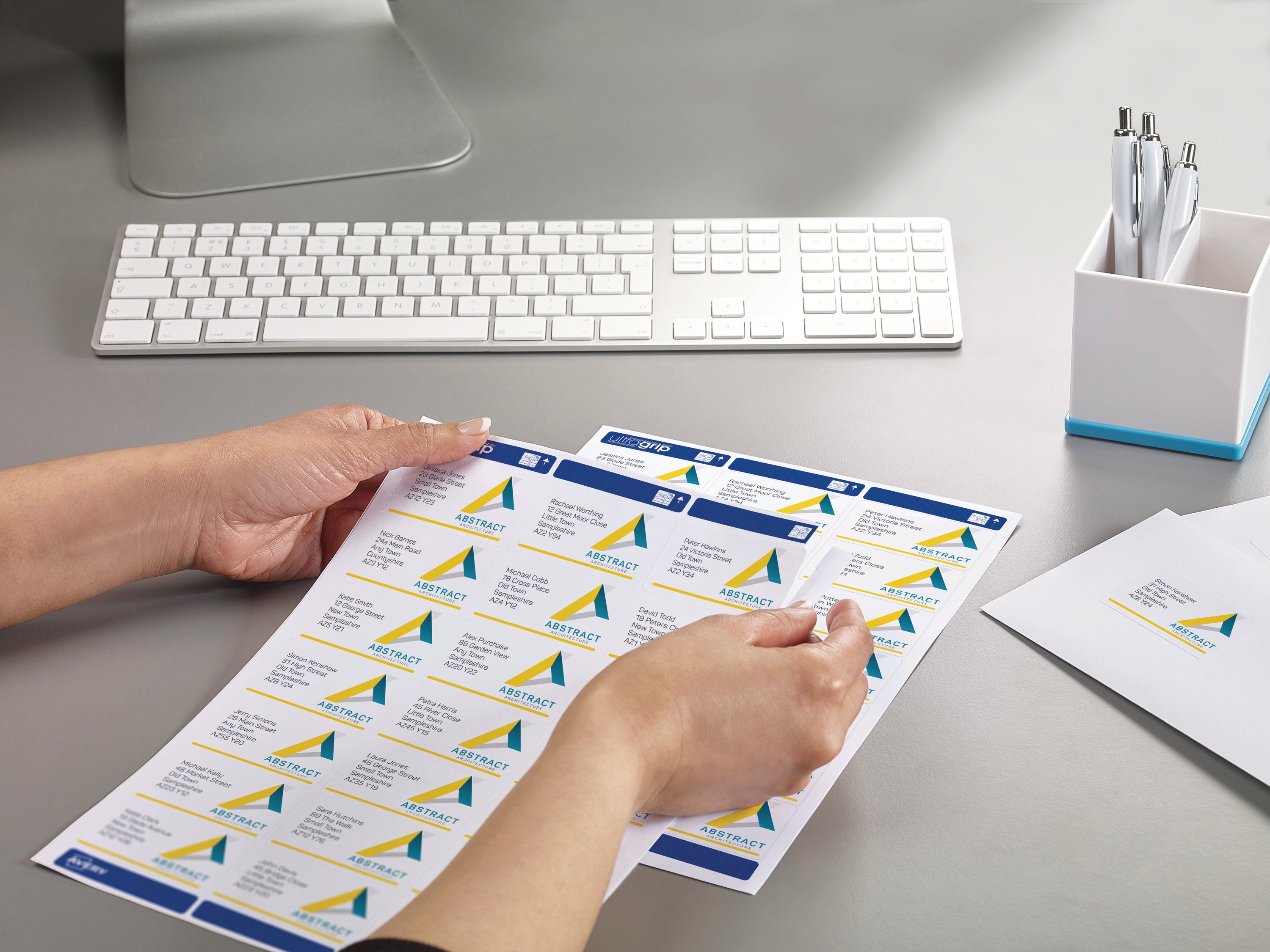 A stack of envelopes neatly addressed using Avery L7160 labels.