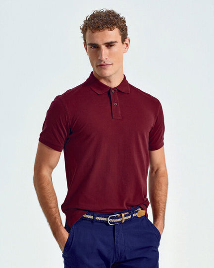 An array of colorful Asquith and Fox men's classic fit cotton polos, model AQ010, folded in a stack.