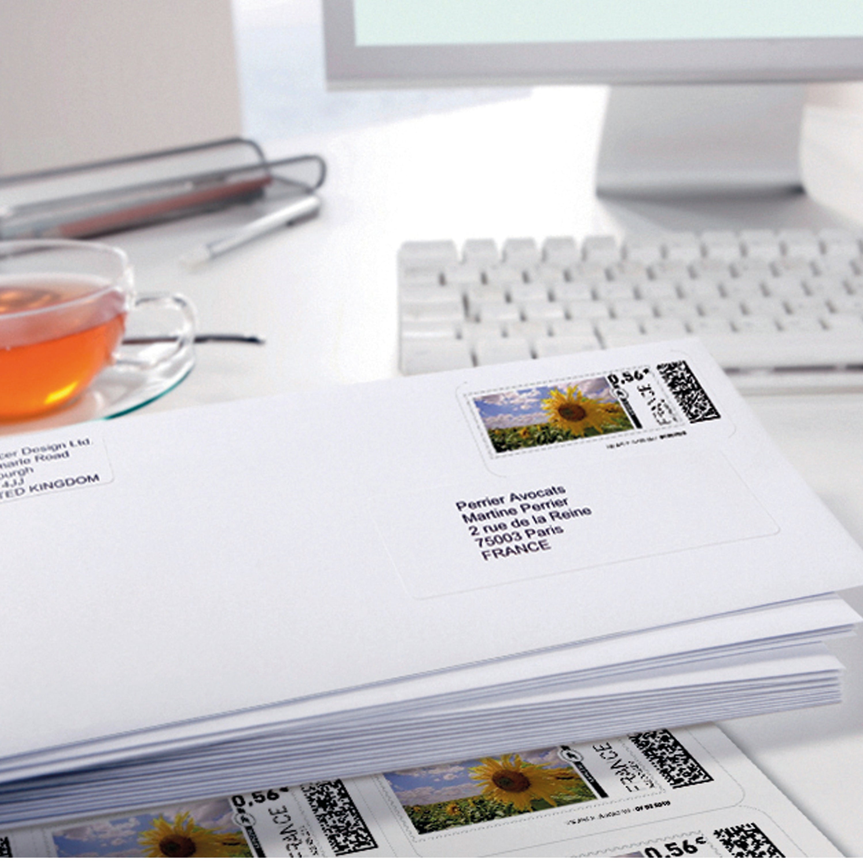 An Avery J8160 white address label applied to a colored envelope.