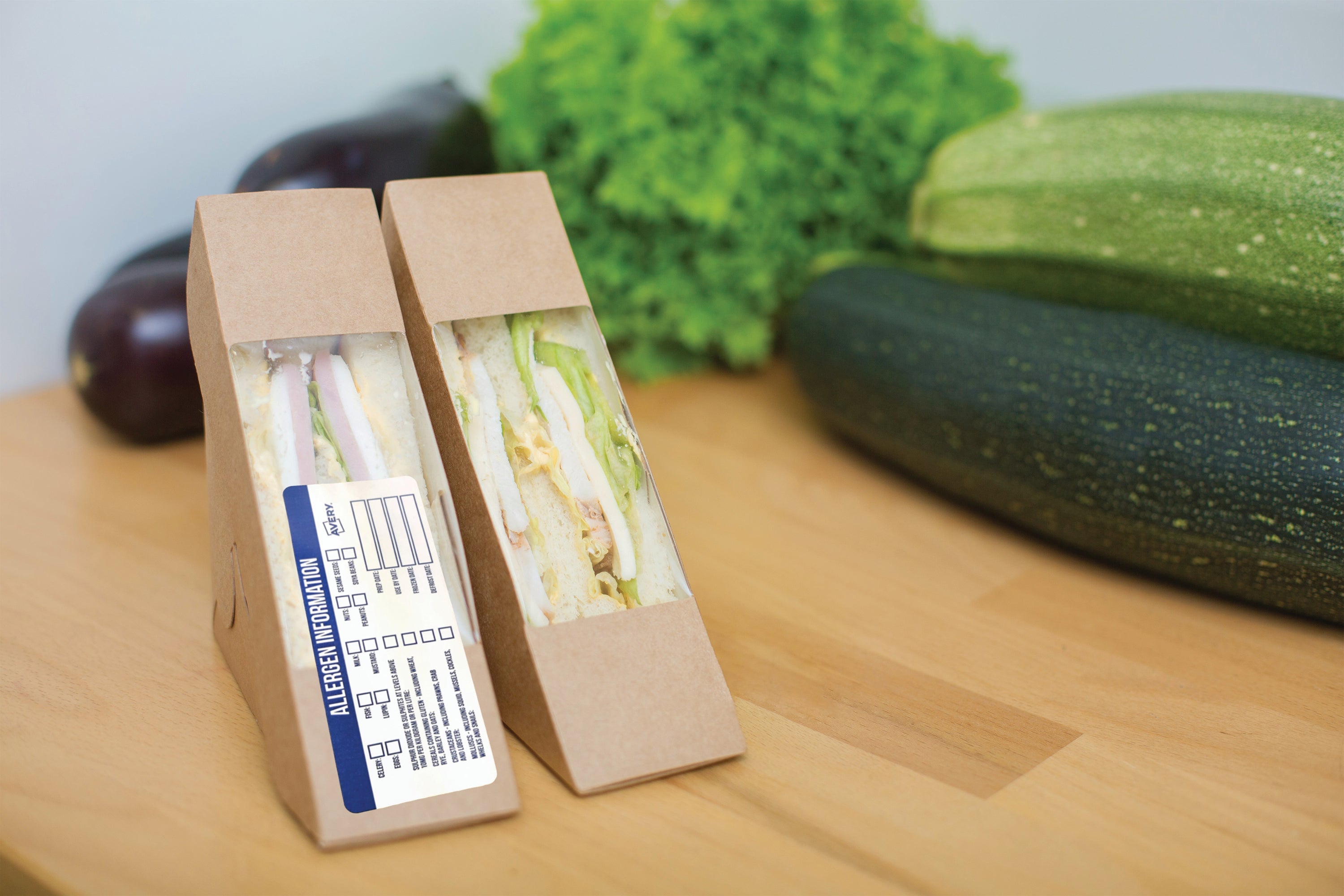 Writing details on a blank Avery allergen food safety label.