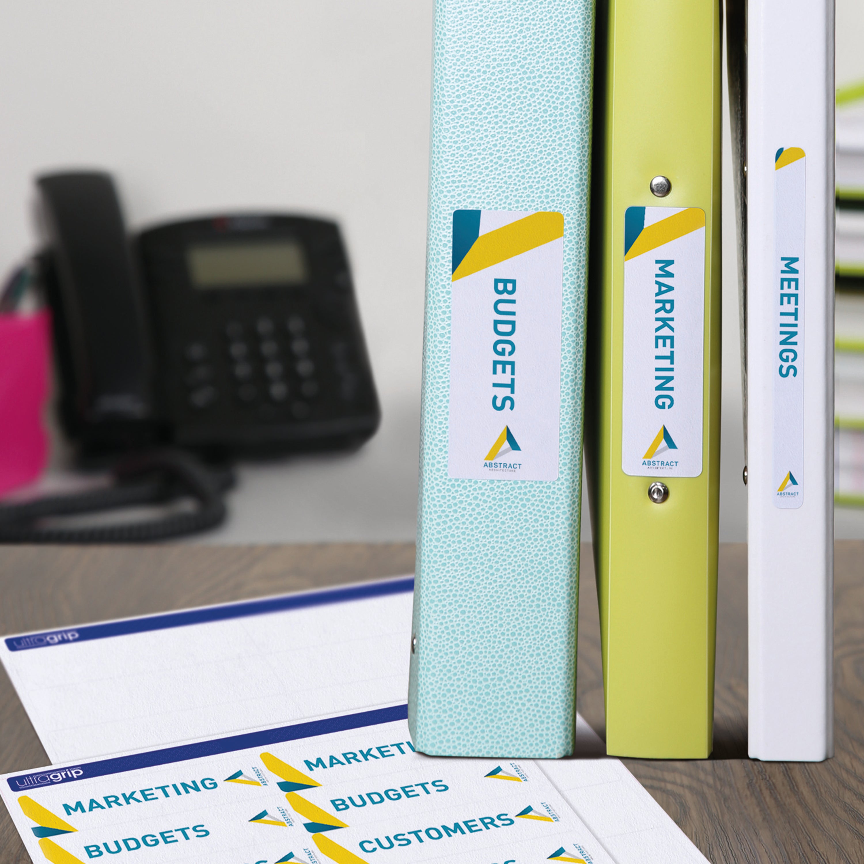 A shelf of binders neatly organized using Avery L7170 spine labels.