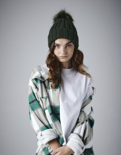 Lifestyle image of a person enjoying the warmth of a Beechfield B413 beanie.