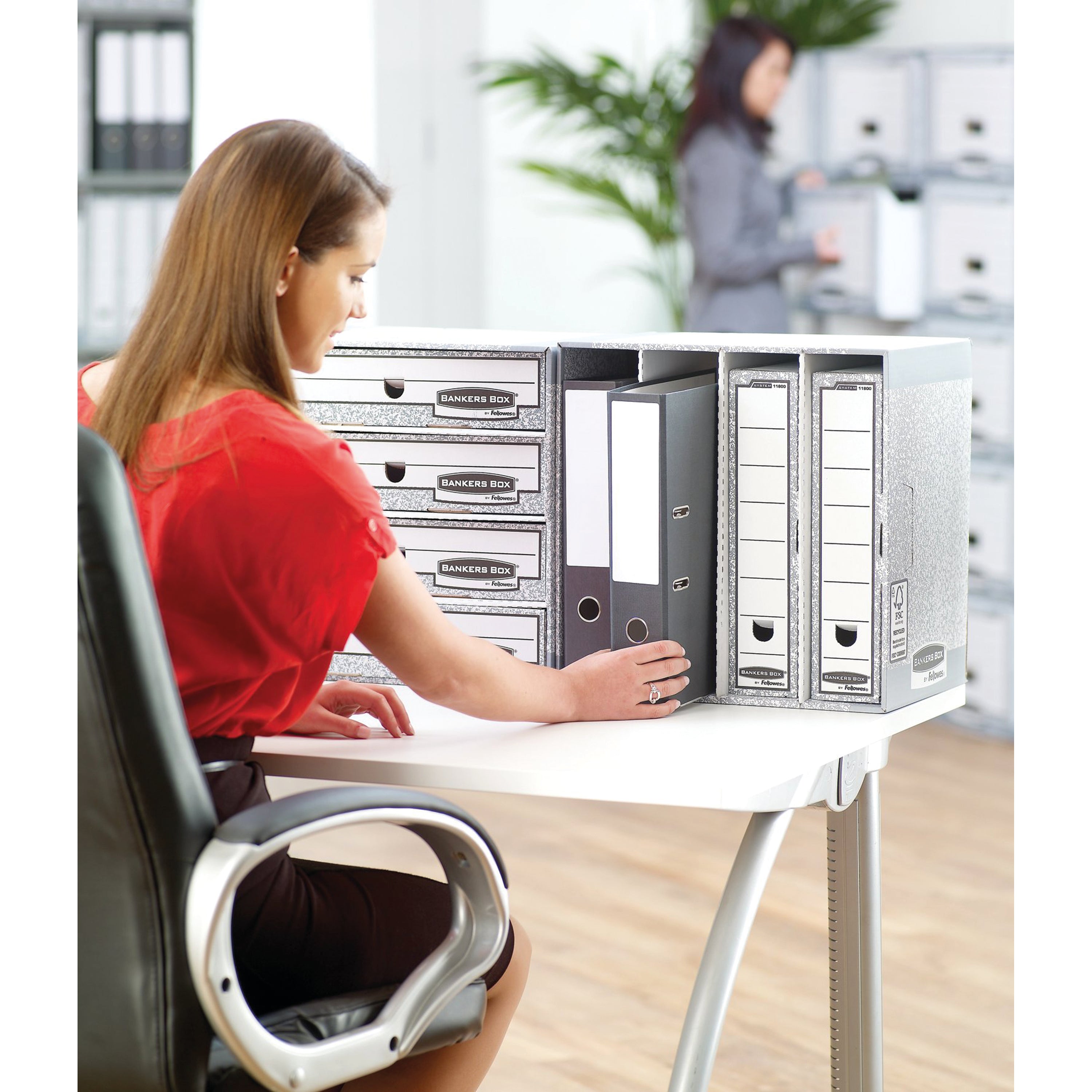 Demonstrating the smooth pull-out action of a drawer from the grey System Stax File Store.