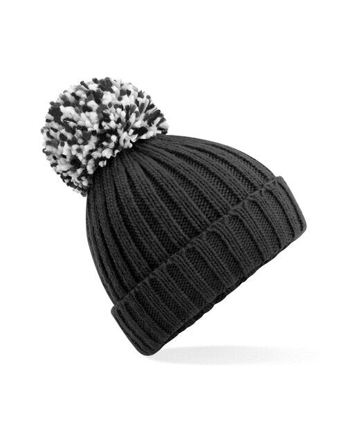 Black Beechfield B390 recycled beanie with a large faux fur pom pom, laid flat.