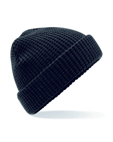 Flat lay of a black Beechfield B422 cable knit melange beanie.