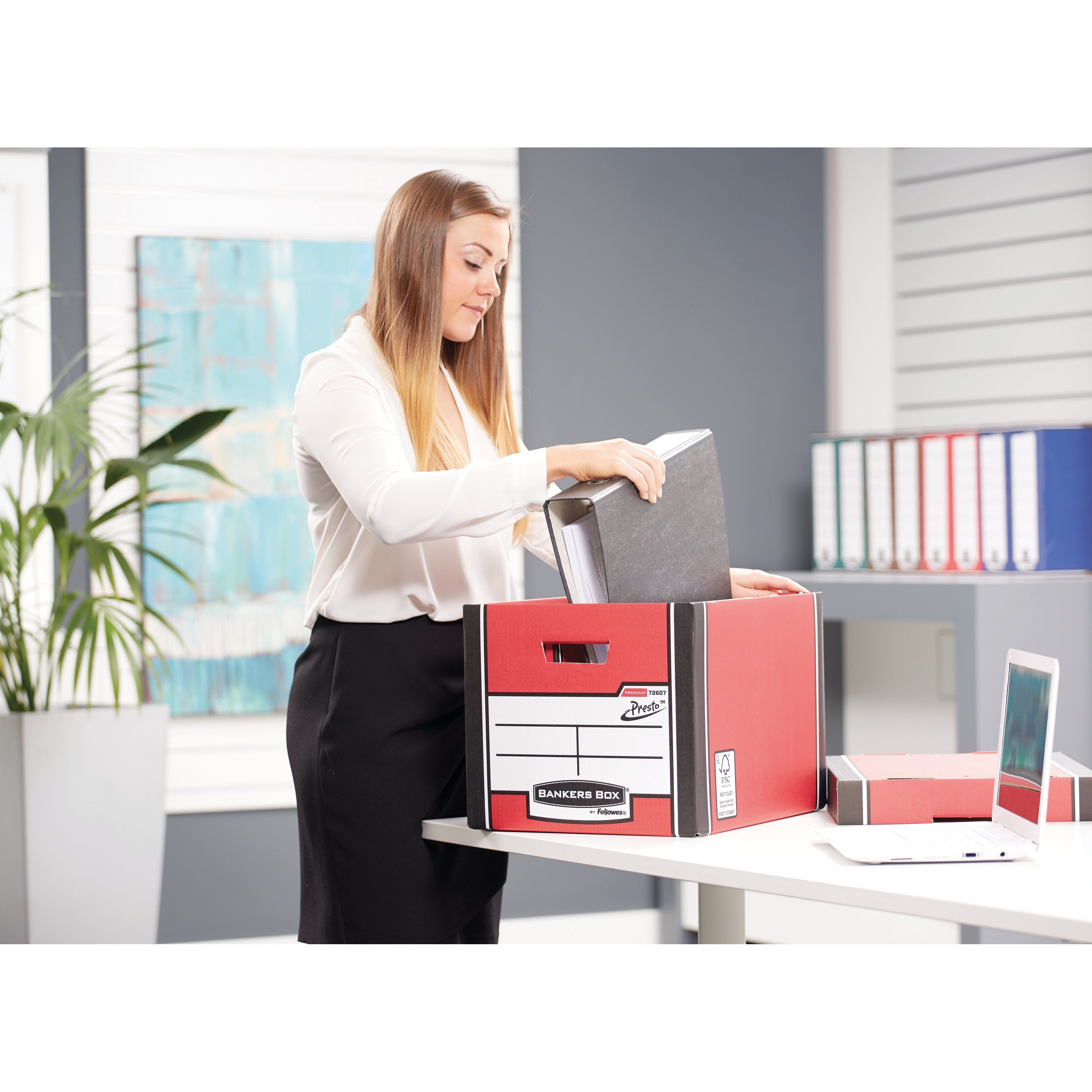 A neat stack of tall red Bankers Box Premium boxes for colorful, organized storage.