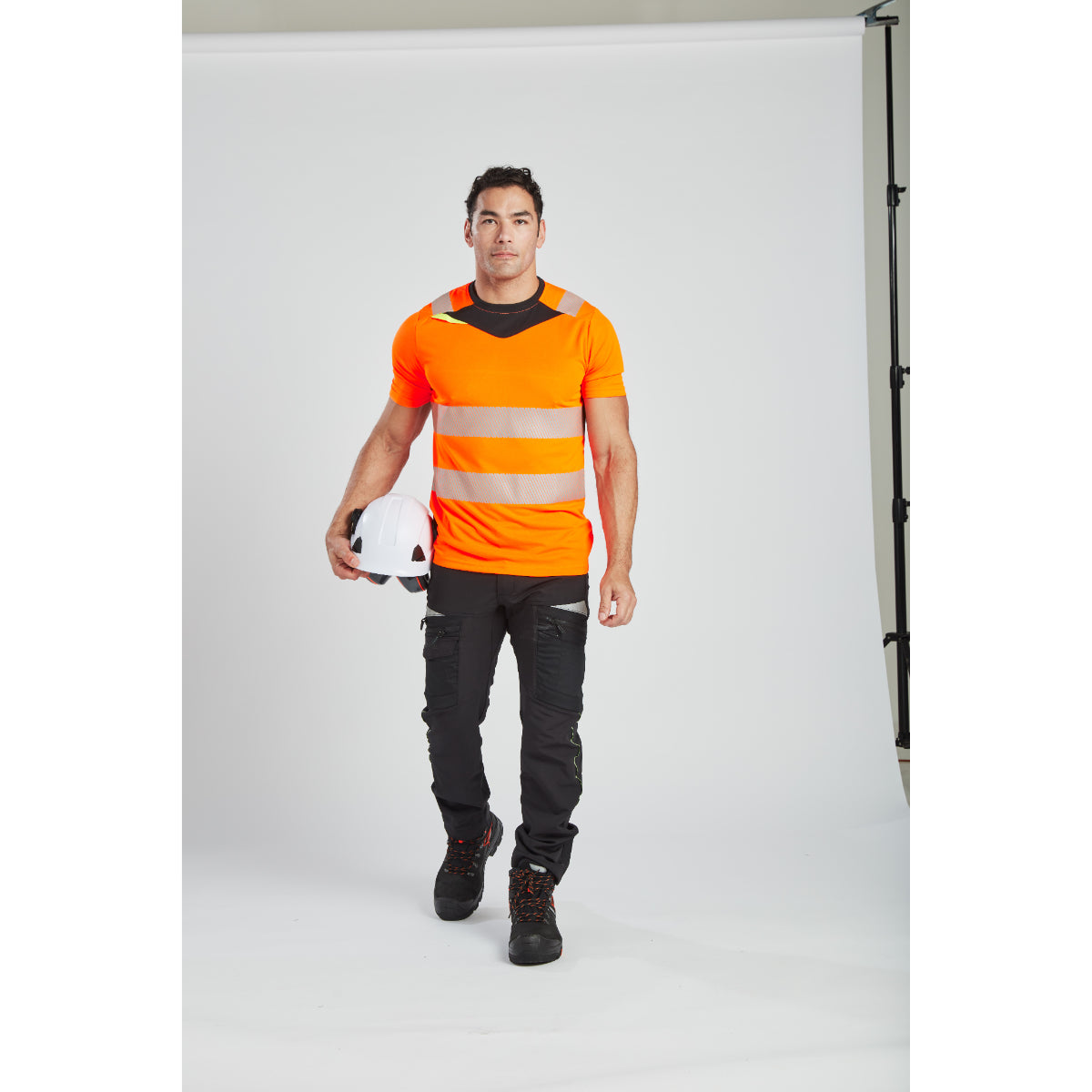 A model looking forward while wearing a Portwest helmet with attached PW62 ear muffs.