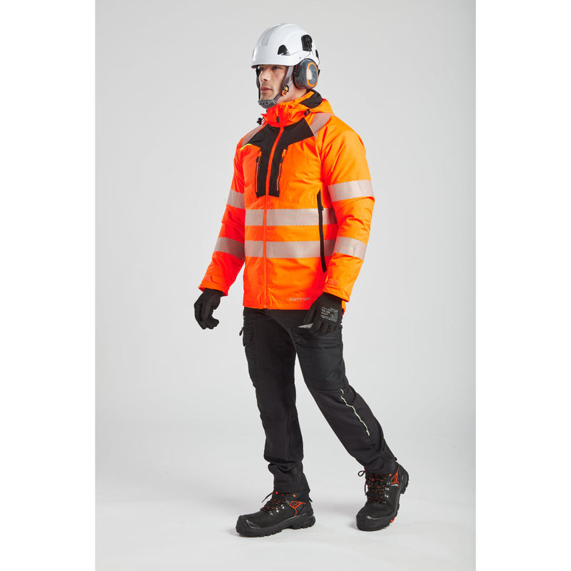 Front view of a model in winter gear, highlighting the Portwest safety headwear.