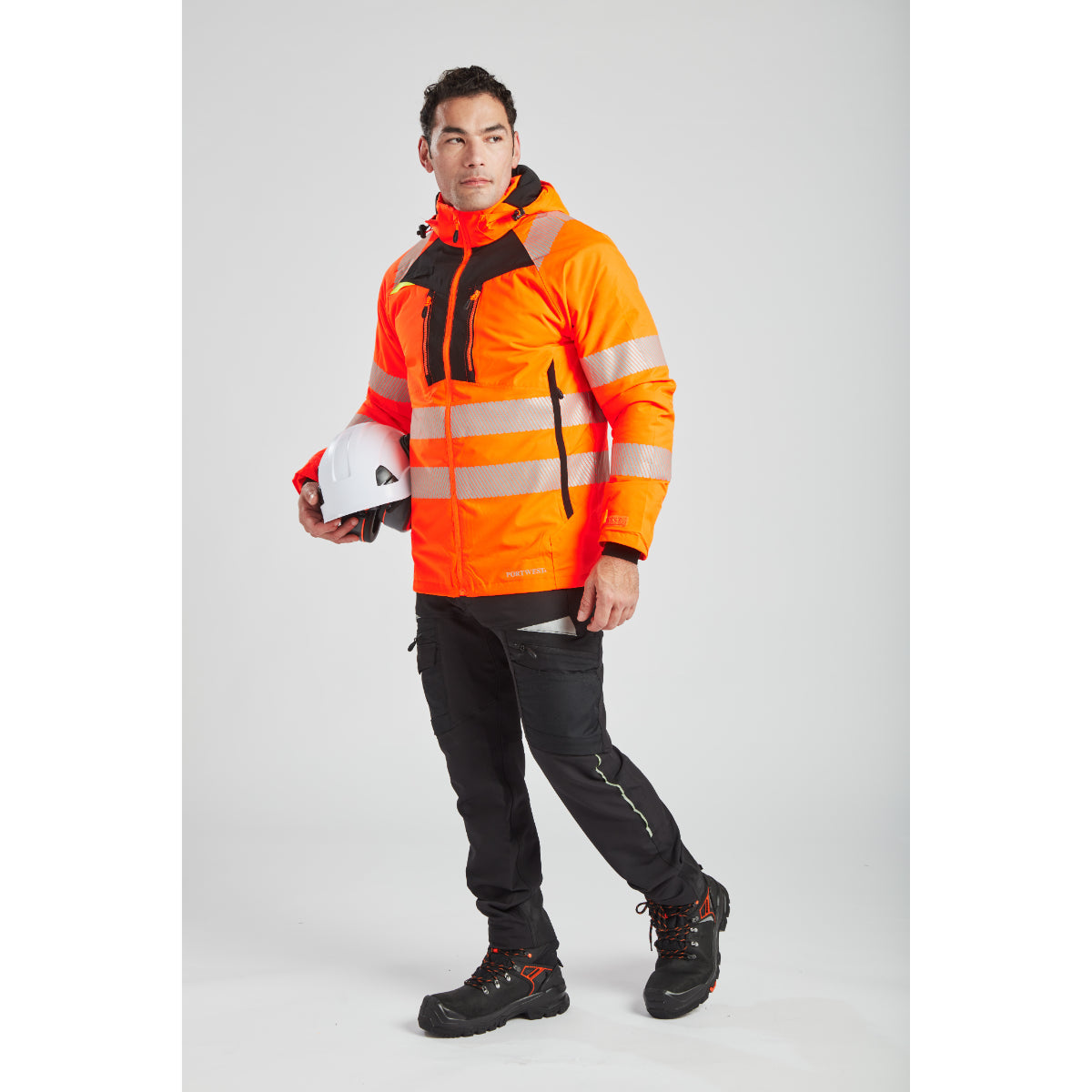A model wearing Portwest outdoor safety clothing, including helmet and ear muffs.