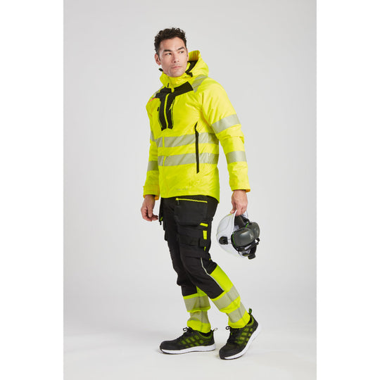 Worker attaching Portwest clip-on ear protectors to a safety helmet.