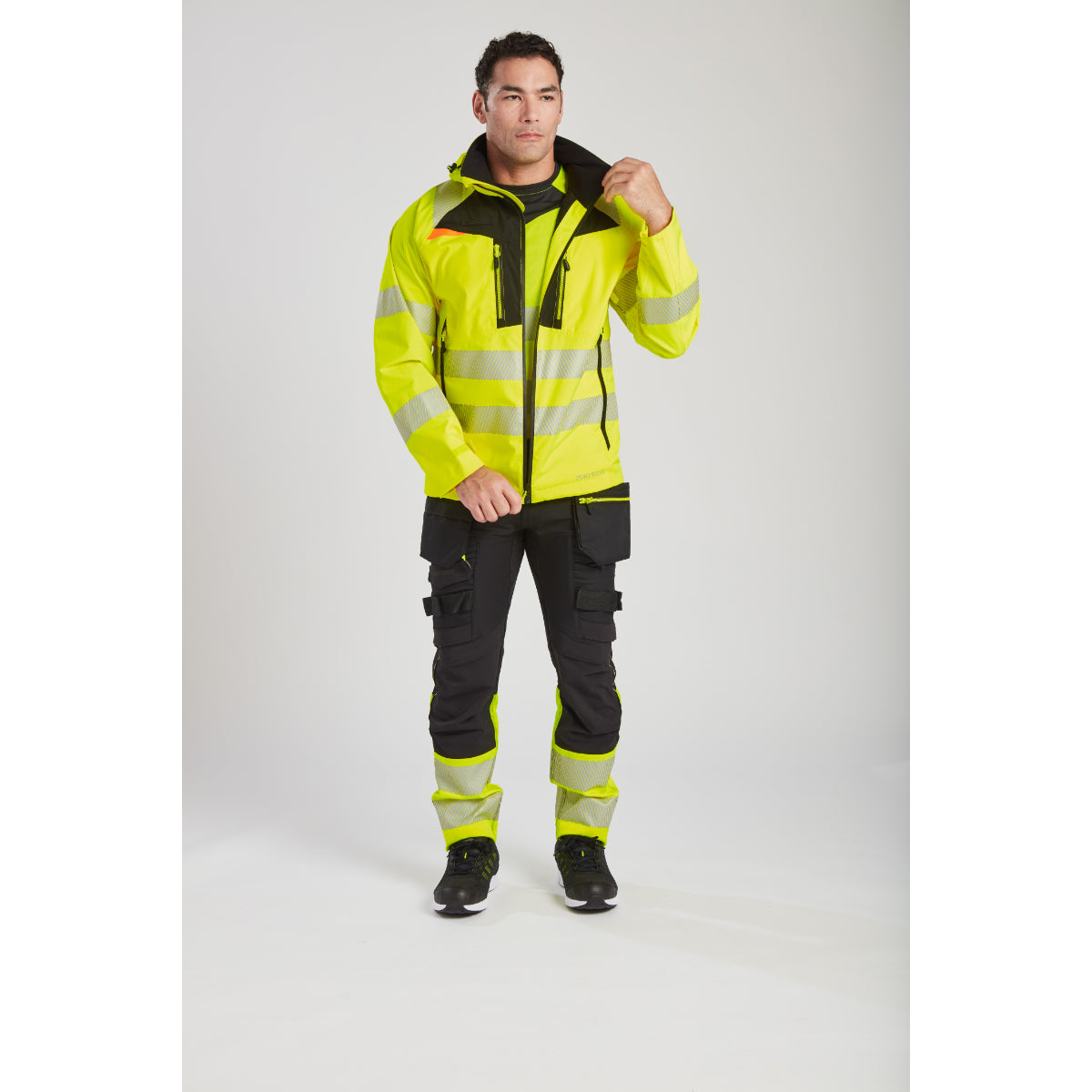 Worker in full Portwest DX4 gear, including the hi-vis rain jacket.