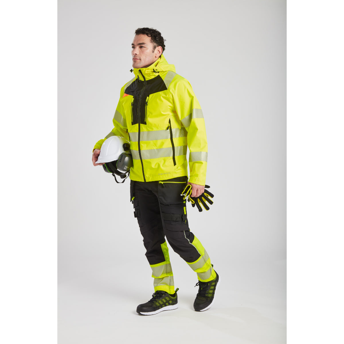 Worker demonstrating the flexibility of the Portwest DX4 rain jacket.