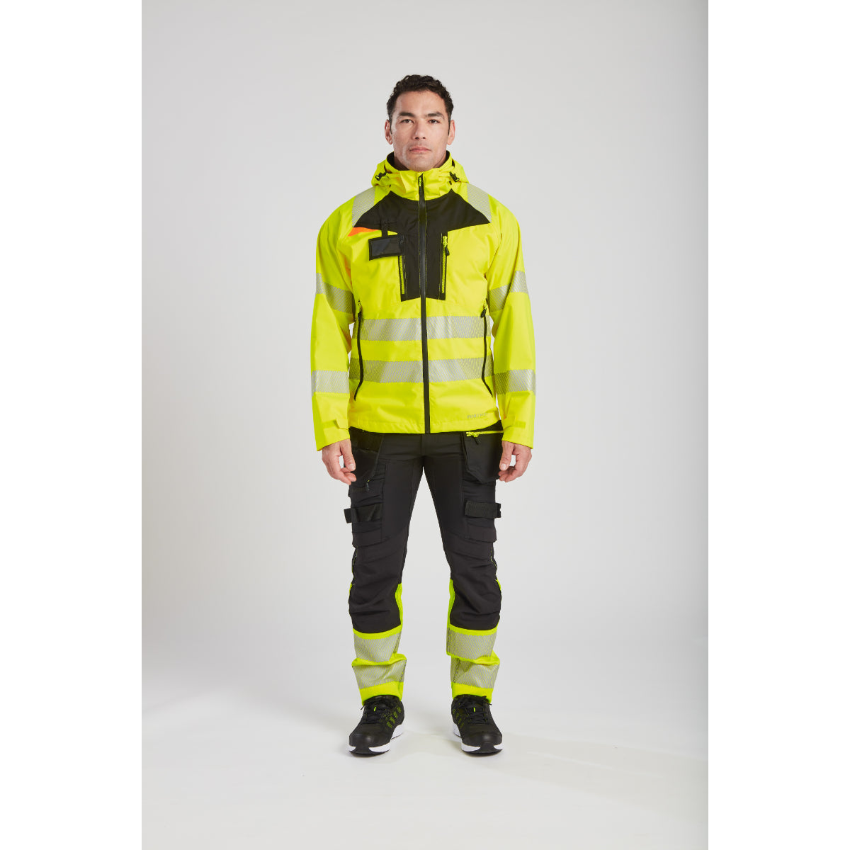 Worker staying dry in the Portwest DX4 Hi-Vis rain jacket.